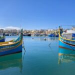 Colourful painted traditional Maltese fishing boats in Marsaxlokk Harbour