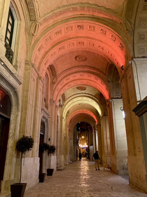 Arched stone passageway outside the national library of Malta