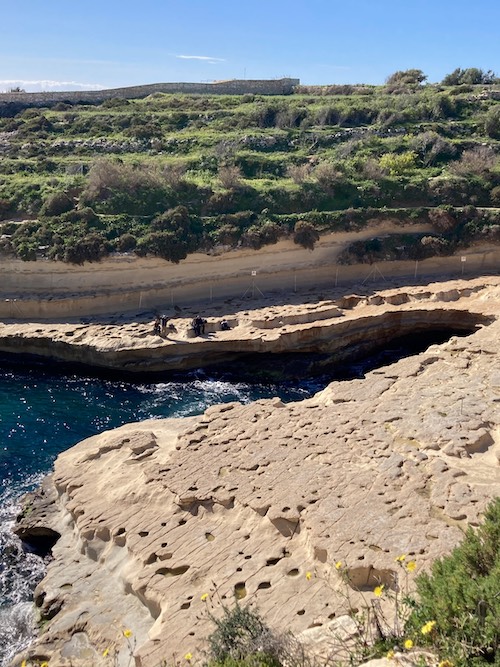 Limestone cove from above at St Peter's Pool in Marsaxlokk Malta