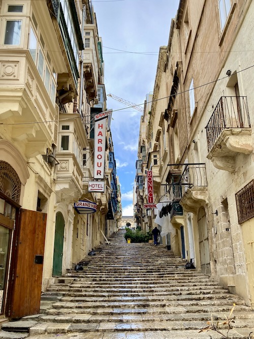 Limestone street of buildings with wooden balconies